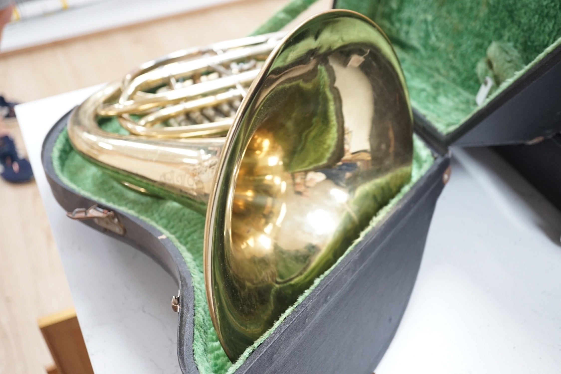 A cased brass telescope and tripod stand, together with a CorTon for Paxman French horn (cased)